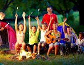 29350695-happy-kids-singing-songs-around-camp-fire